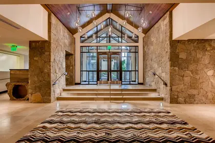 The Lion Vail lobby entrance with stone walls via Expedia