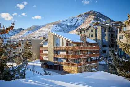 Enzian Vail balconies with snowy peaks behind via Expedia