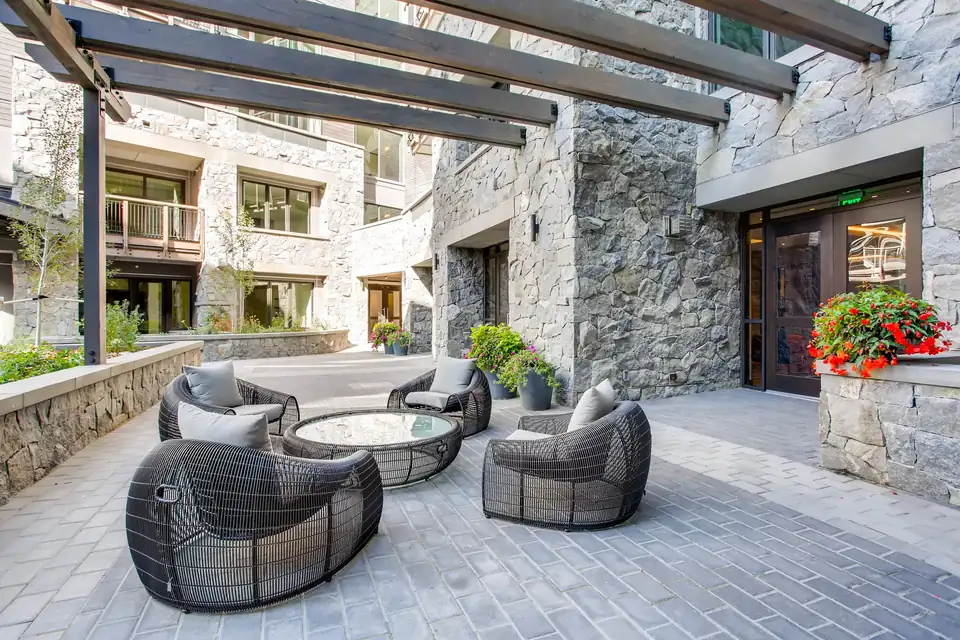 The Lion Vail stone courtyard with outdoor seating via Expedia