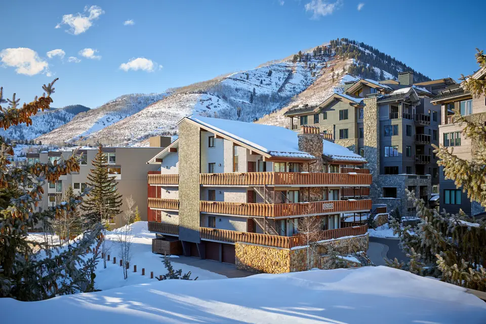 Enzian Vail balconies with snowy peaks behind via Expedia